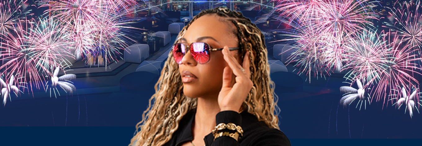 Cool chick wearing shades with fireworks in the background